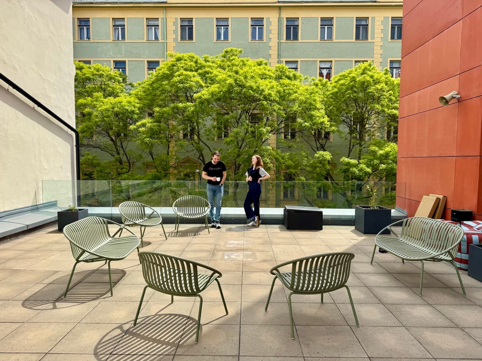Two teammates chatting on the rooftop terrace